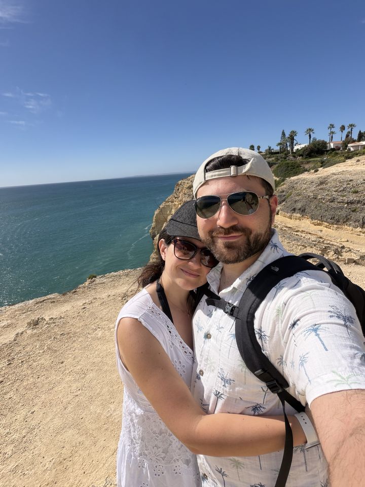 Jessica and Rami taking a selfie on sunny sea cliffs
